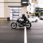 Motorcyclist speeds through a busy city street in San Francisco, California.